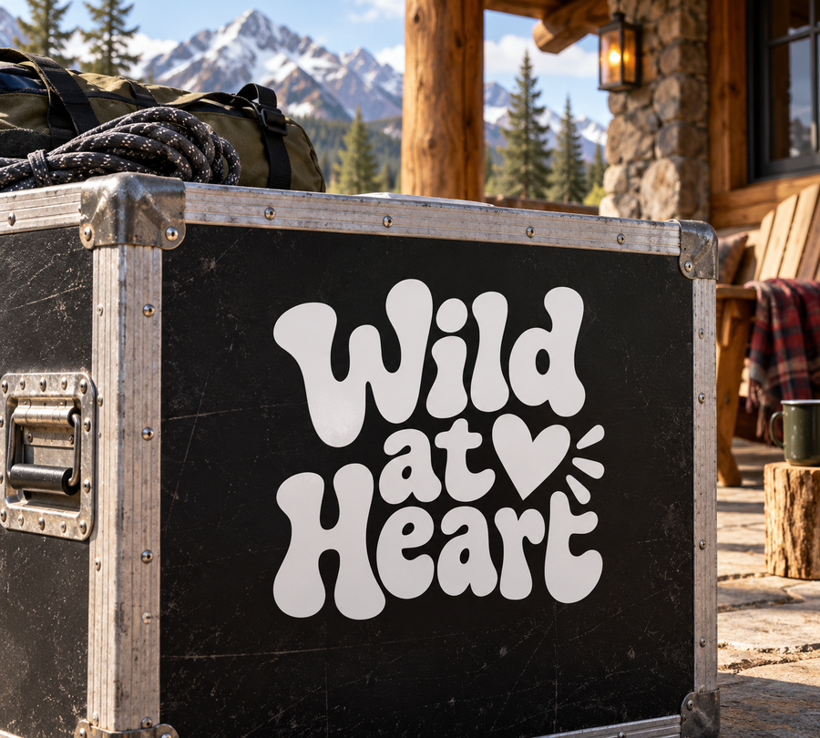 Black vinyl decal with white “Wild at Heart” lettering and heart with spark lines