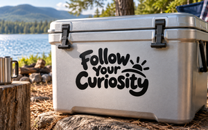 Follow Your Curiosity vinyl decal with bold black lettering and paw-print accents