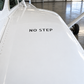 Aircraft stencil label reading "NO STEP" on white fuselage surface