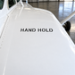 Stencil aircraft label with "HAND HOLD" text on a white airplane surface