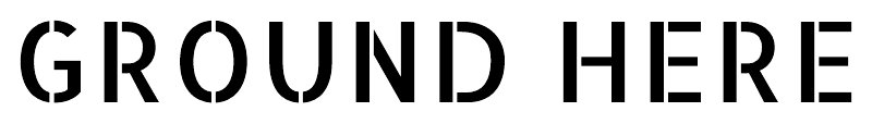 Close-up of black “GROUND HERE” lettering on a white label plate.