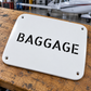 White baggage stencil aircraft label with 'BAGGAGE' and four corner holes
