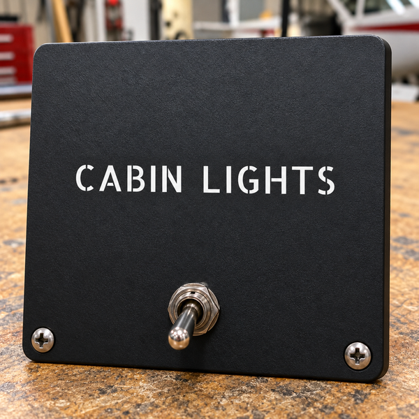 Cabin Lights aircraft label, black rectangular plate with screw holes and two terminals