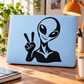 Peace-sign alien vinyl decal sticker, black graphic on light blue laptop lid