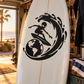 Alien surfer vinyl decal, black graphic on clear/white surface.