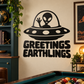 Black alien UFO vinyl decal with “GREETINGS EARTHLINGS” text, white accents