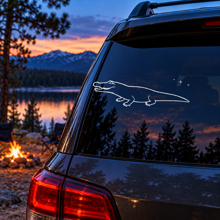 Alligator window decal with open jaw, ridged back outline, and small constellation spark cluster