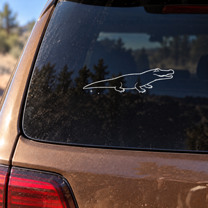 Mirrored open-jaw alligator decal outline with ridged back and spark trail
