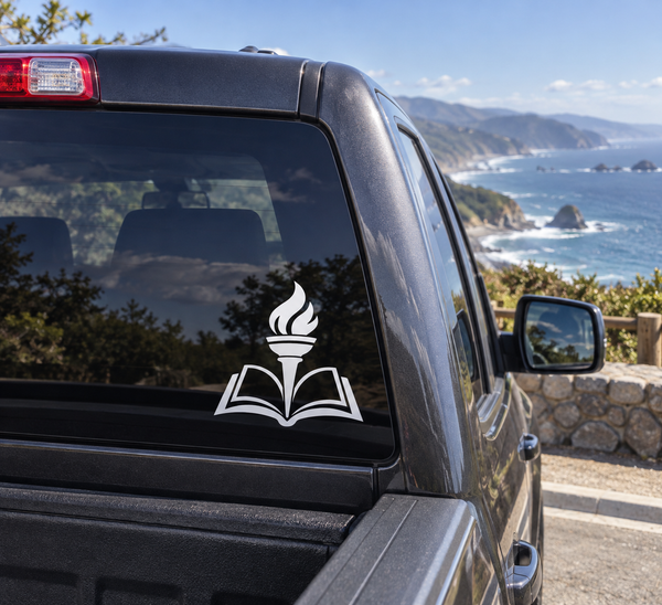 Torch and book vinyl decal on car window, black open-book icon with flame