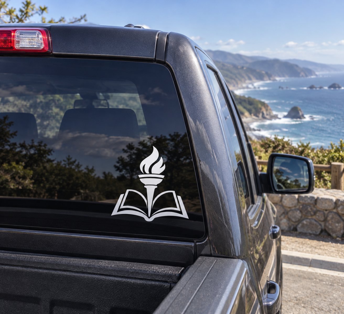 Torch and book vinyl decal on car window, black open-book icon with flame