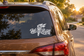 White We The People vinyl decal with torch and flame on car rear window