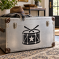 Vinyl drum and star decal with black drum icon on silver-toned surface