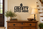 Liberty Lives Here vinyl decal with flame icon and bold black text on wall