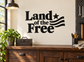 Vinyl wall decal with 'Land of the Free' text, star and striped flag graphic, black