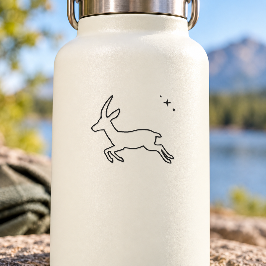 Cream water bottle with leaping antelope line art and small star accents