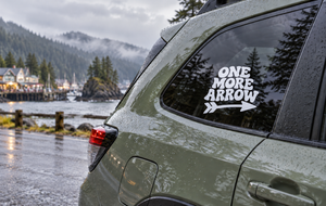 Vinyl decal with "ONE MORE ARROW" text and arrow graphic on a car window