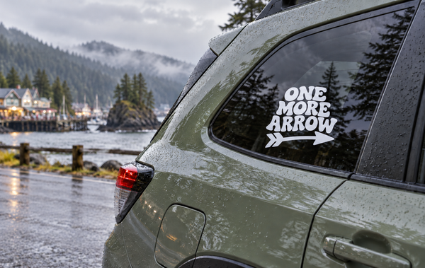Vinyl decal with "ONE MORE ARROW" text and arrow graphic on a car window