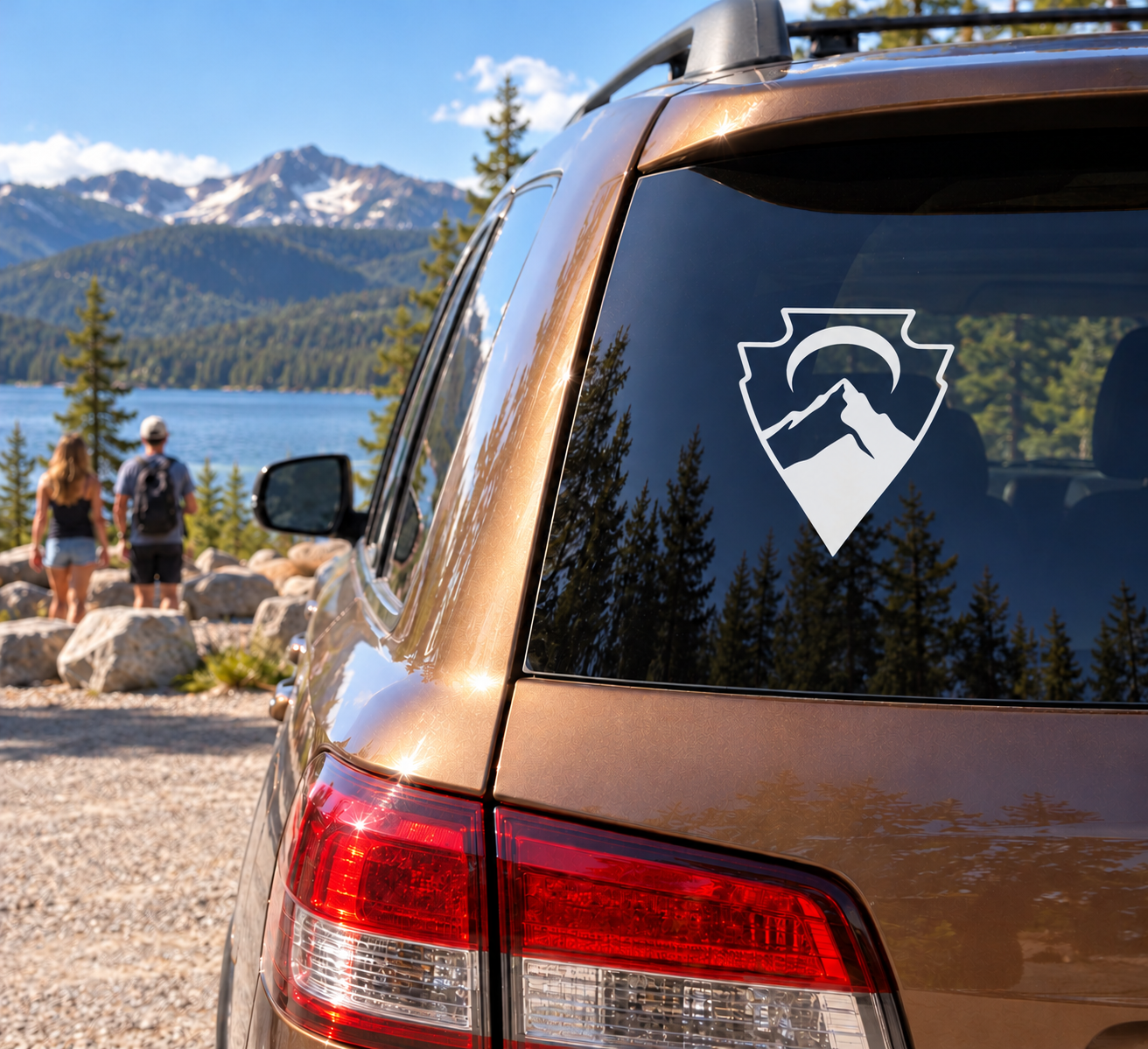 Vinyl decal on car rear window: white shield with mountain and crescent arrow