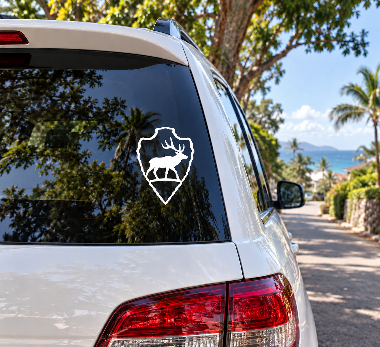 Elk arrowhead vinyl decal in white outline on dark car window