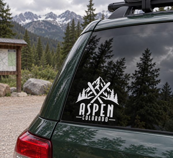 Aspen crossed skis wordmark vinyl decal in white on dark green car window