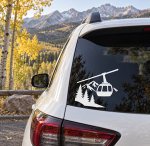 Black vinyl decal of gondola over pine trees and mountain peaks for car windows