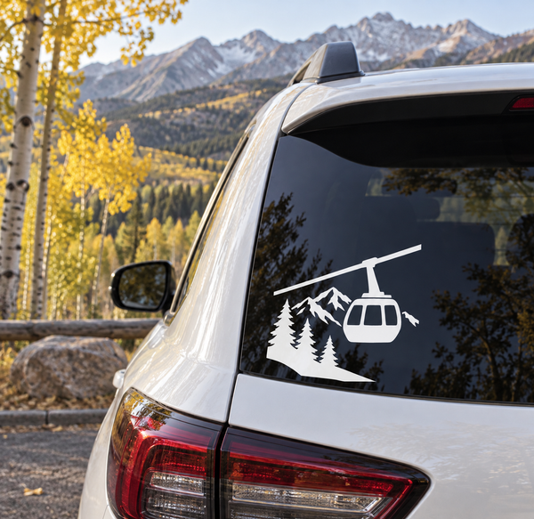Black vinyl decal of gondola over pine trees and mountain peaks for car windows