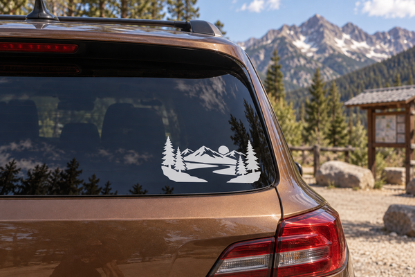 Alpine river horizon vinyl decal on car rear window with pine trees and mountains