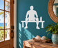 White vinyl workout decal: seated lifter on weight bench with dumbbells and bottle