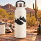 Pair of black athletics track shoe vinyl decals on a white bottle