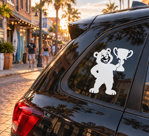 Black bear vinyl decal holding a trophy on a car rear window