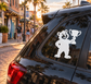 Black bear vinyl decal holding a trophy on a car rear window