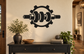 Black gear-and-cylinder wall decal with central emblem design