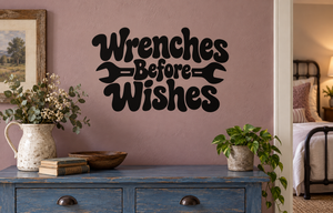 Black “Wrenches Before Wishes” wall decal lettering with wrench icon accents