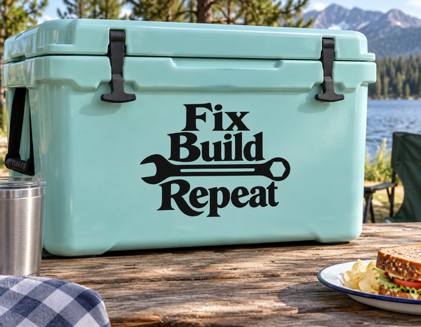 Light mint cooler with black latches and front text "Fix Build Repeat"