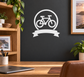 Cycling emblem vinyl decal with bicycle inside medal ring and ribbon banner