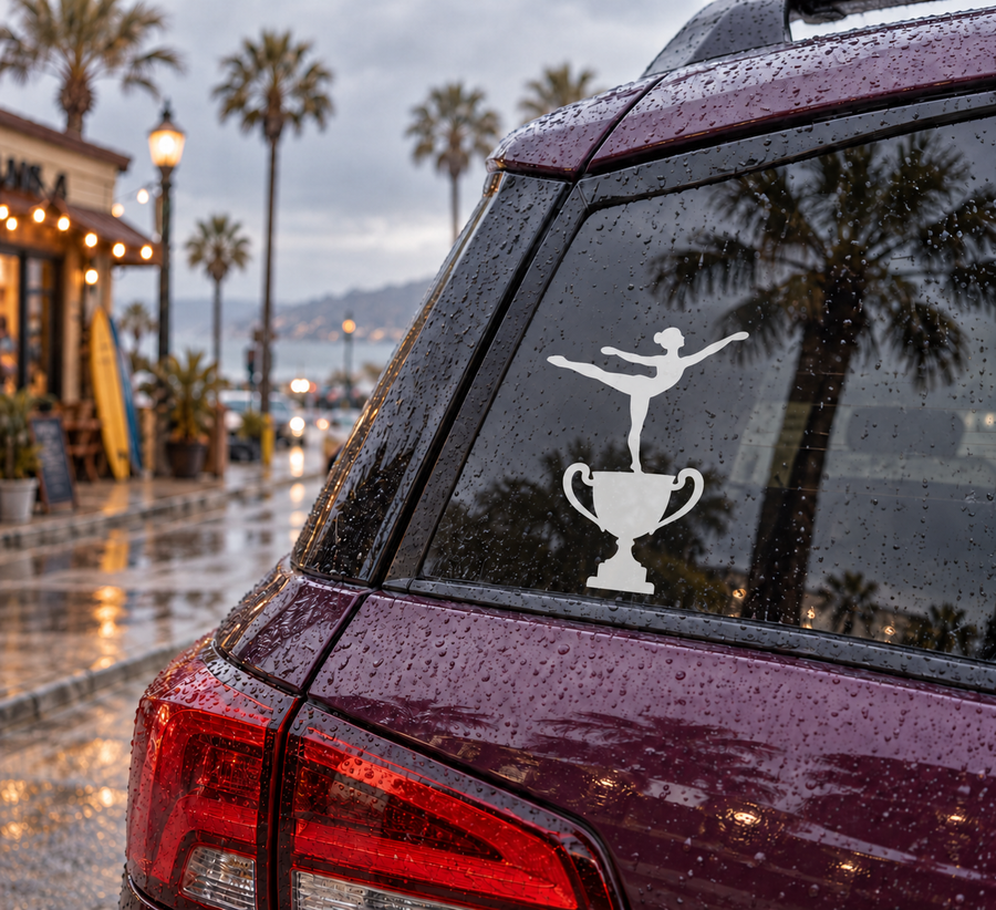 Gymnastics vinyl decal on car rear window: black gymnast silhouette and trophy