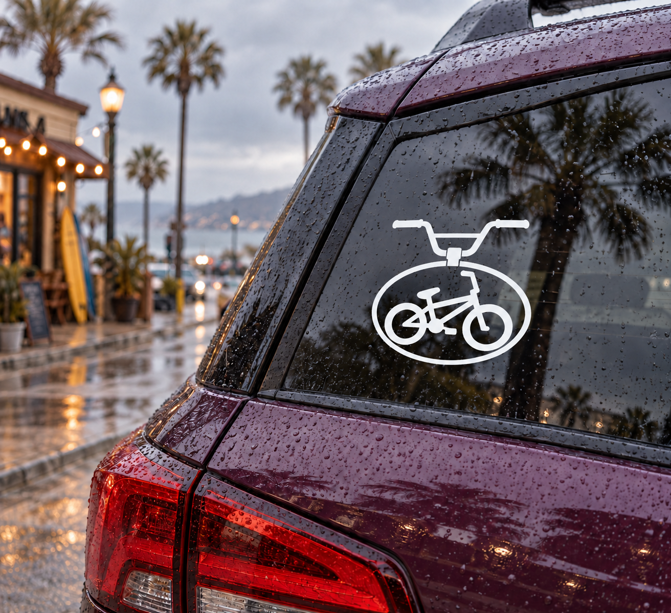 BMX vinyl decal with white bike icon on dark window glass