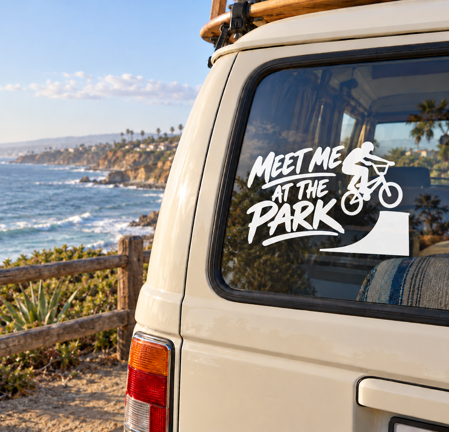 Vinyl decal on car window: “Meet Me at the Park” with black BMX rider