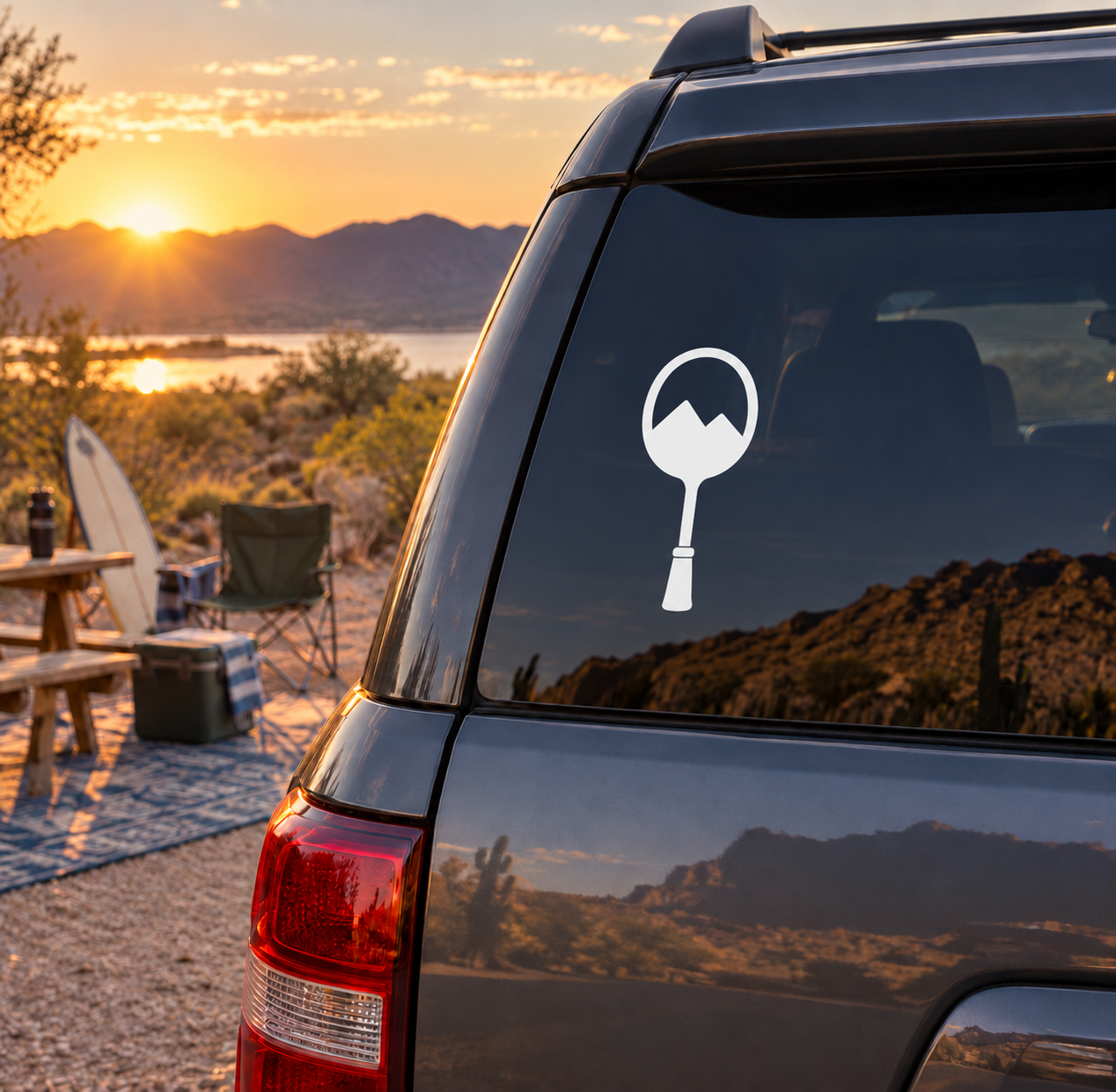 Window vinyl decal with white racket and mountain emblem on car window