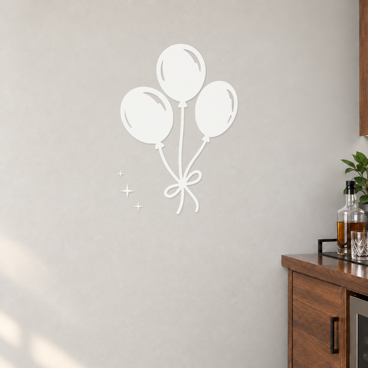 Three white mirrored party balloons with tied ribbon bow and small sparkles
