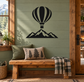 Hot air balloon and mountain vinyl wall decal, black design on a pale green wall