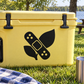 Black bandage-and-leaf vinyl decal with white outline and small dots on a surface