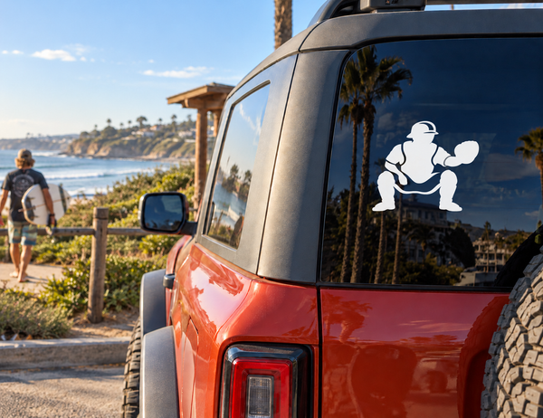 Baseball catcher vinyl decal in white silhouette on a vehicle rear window