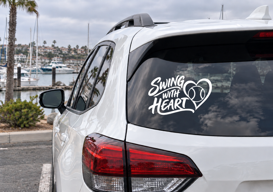 Vinyl decal on car rear window: Swing With Heart script with heart and baseball icons