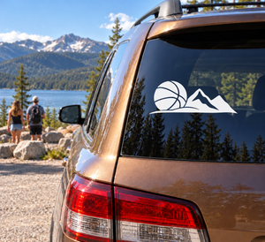 Vinyl basketball and mountain decal on car rear window, white design