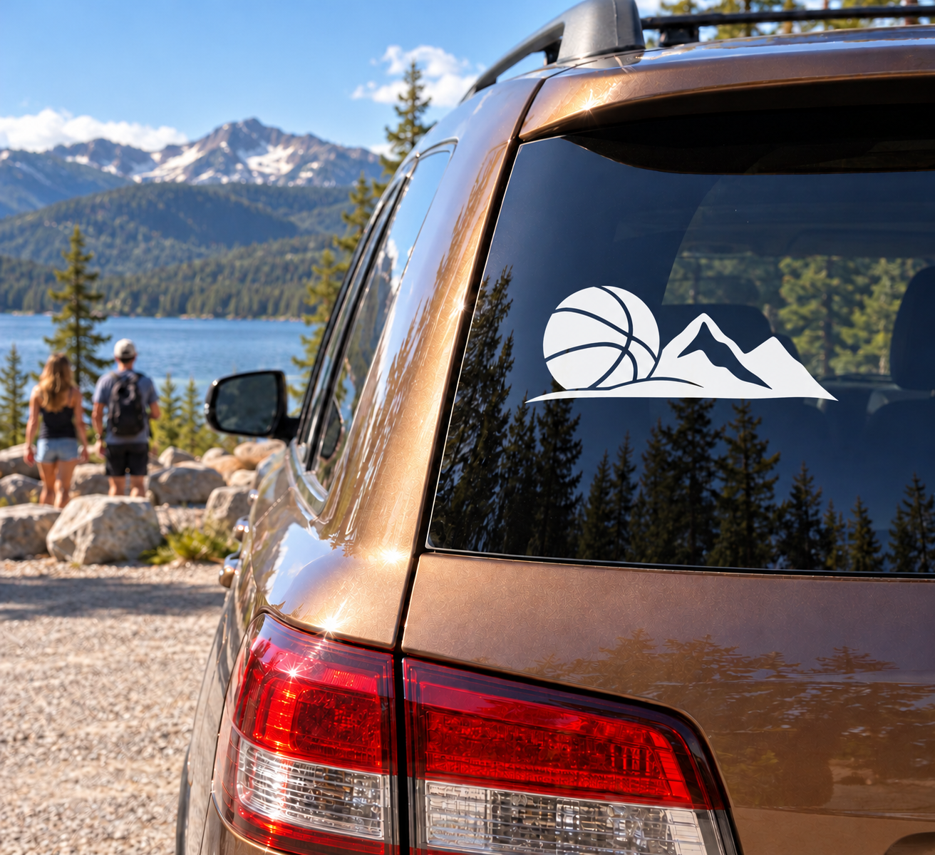 Vinyl basketball and mountain decal on car rear window, white design