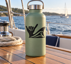 Black shaka hand and wave fin vinyl decal on a light green bottle