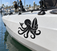 White boat hull with black octopus vinyl decal near a corner