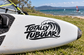 Vinyl decal with Totally Tubular logo in black on surfboard nose