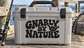Vinyl decal reading 'Gnarly by Nature' with fist graphic, black lettering on light background.